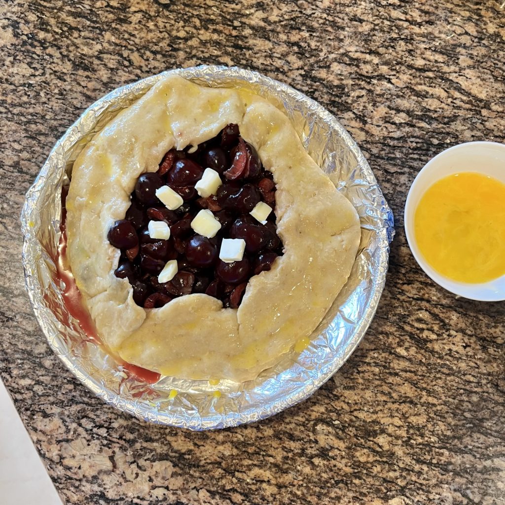 Cherry galette next to egg wash