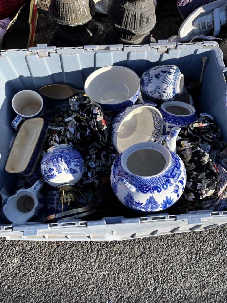 Box of fine china at the flea market