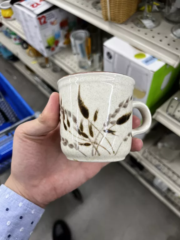 Cup with weeds on it